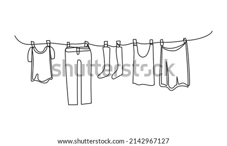 Continuous one line drawing of laundry hang on clothline. Vector illustration	
