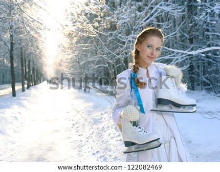 Young smiling girl with skates in forest