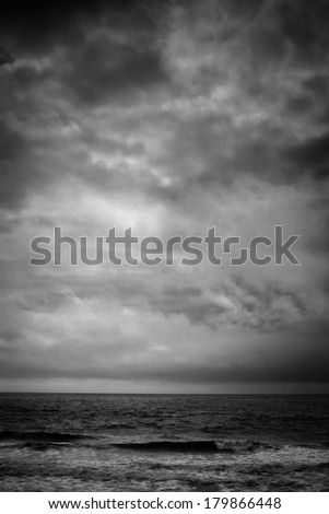 A black and white shot looking out to the Pacific Ocean during a cool winter storm.