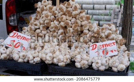 Lots of garlic in a crate on the counter at the local market. These garlics are a natural source of antibiotics. It is extremely beneficial to consume garlic against diseases, especially in winter. Stok fotoğraf © 
