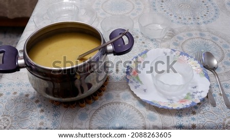A very nice handmade lentil soup is on the table. It looks healthy and very tasty. There are plates and bowls on the table. Healing soup. Stok fotoğraf © 