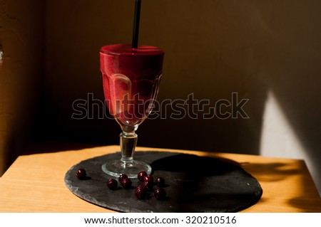 healthy organic detox smoothie from berries on a concrete diy plate wood table background overhead view cool shadows natural light