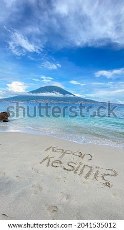 “Kapan kesini?” Means when come here? Come to enjoy this little beautiful beach with white sand and view of Ternate Island, North Molucas. This beach called “Pantai Pasir Putih” located in Cobo,Tidore Zdjęcia stock © 