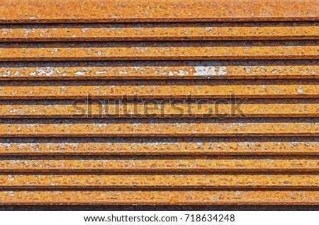 The rusty metal L-bar angle in packs at the warehouse of metal products piled in the open air Stock fotó © 