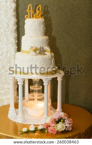 wedding cake for bride and groom with candles and flowers