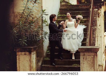 nice sweet happy bride and groom holding hand on the old stairs in Rome Italy