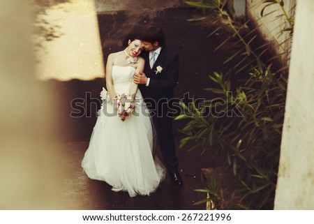 cute sweet happy bride and groom holding hand and hugging on the old street in Rome Italy