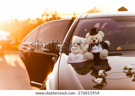 couple toys teddy bear in dress suit decoratet wedding car