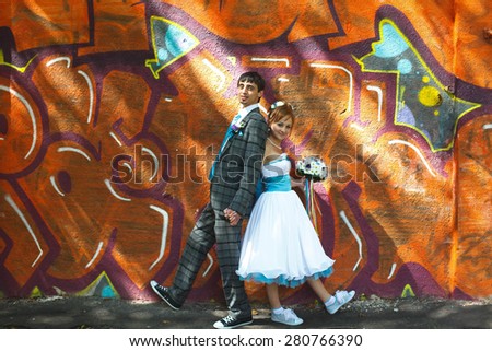 happy couple posing on background  graffiti