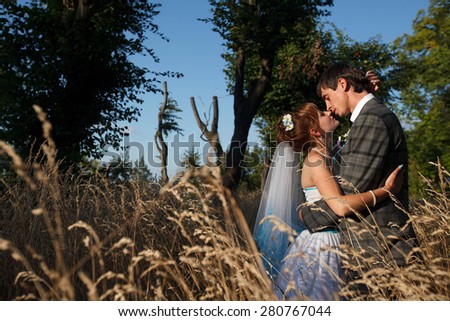 tenderness couple is hugging and kissing on the background summer evening