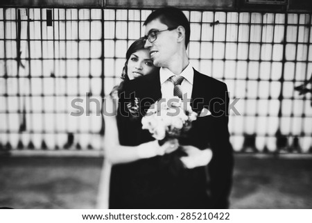 cute young gentle stylish bride and groom on the background  abandoned  building