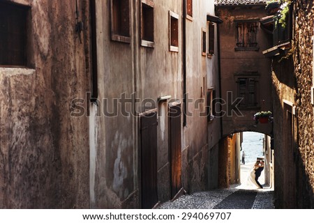 sweet romantic beautiful happy couple strolling stone streets of the ancient city, mediterranean sea, mountains