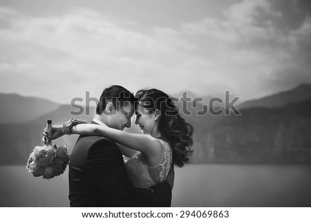 luxury happy couple on the background amazing landscape of the blue sea high mountains