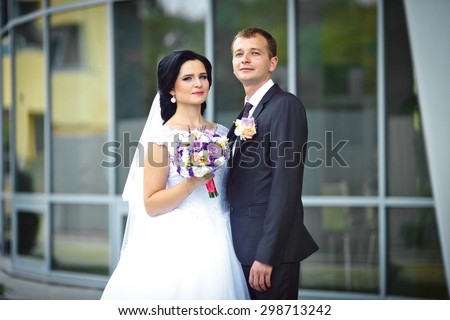 romantic gentle gorgeous bride and groom on the background of modern futuristic architecture, Lviv, wedding