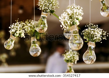 Original wedding floral decoration in the form of mini-vases and bouquets of flowers hanging from the ceiling Foto stock © 