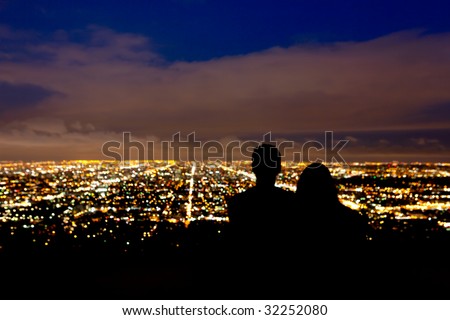 Romantic couple takes in the view the city lights