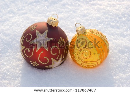 Two beautiful decorative spheres on a white snow.