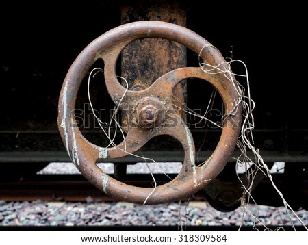 rusty metal valve,Industrial Valve Wheel,rusty valve with weed