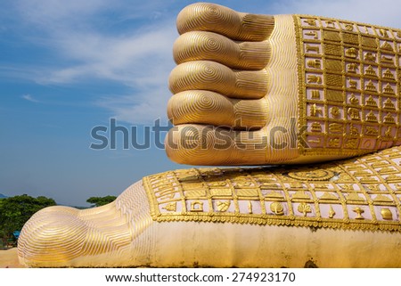 A foot print big statue of reclining buddha image in the temple, Phrae province Thailand