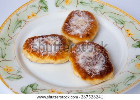 cottage cheese pancakes with powdered sugar on a plate