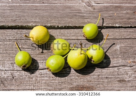 Wild ripe juicy pear on the vintage wooden table. Vintage wooden old table.