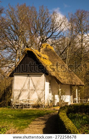 Old timbered garden house with thatched roof