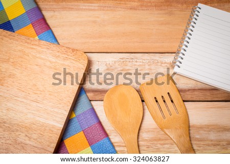 Fork, Knife,book diary and Table Cloth on wooden background. Top view