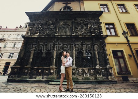 couple walk in old town lvov, kiss and love