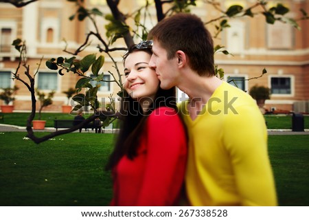 loving couple sitting near lemon tree in the garden of the Vatican Museum
