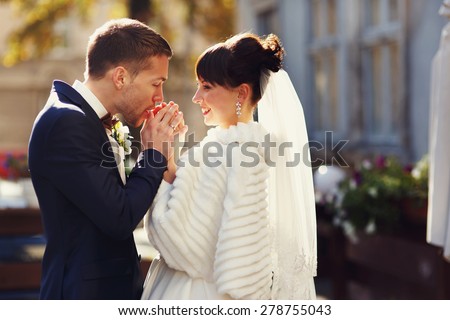 groom hands warm breath of his bride
