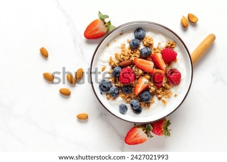 Image, Stock Photo Healthy breakfast. Bowl with cereals, raspberries and blueberries next to oranges