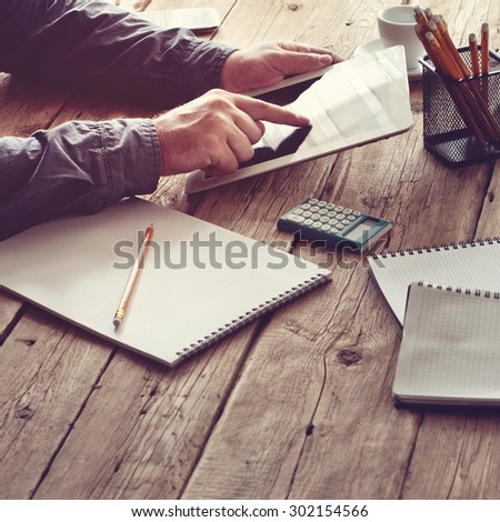 white tablet computer in men hands. concept man working from home using tablet computer or working outside the office. Free space for text. top view. Copy space. Square frame