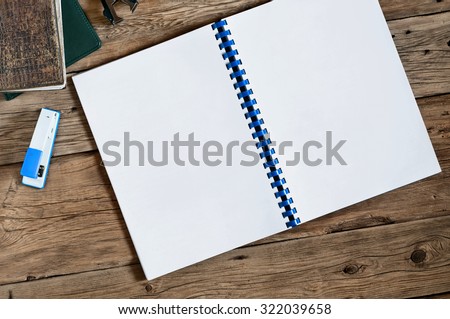 Open blank notebook with blank white pages closeup. Top view