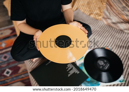 Similar – Image, Stock Photo Woman holding vinyl record. Music passion. Listening to music from analog record. Playing music from analog disk. Enjoying music from old collection. Retro and vintage. Stereo audio. Analog sound