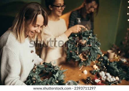 Similar – Image, Stock Photo Woman making Christmas wreath of spruce, step by step. Concept of florist’s work before the Christmas holidays.