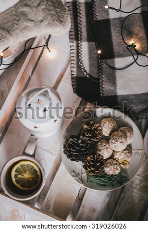 Christmas still life with tea, lights, cones and cookies