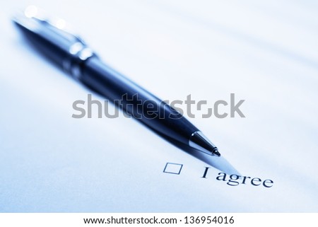 Pen and clause of an agreement. Blue color tone.