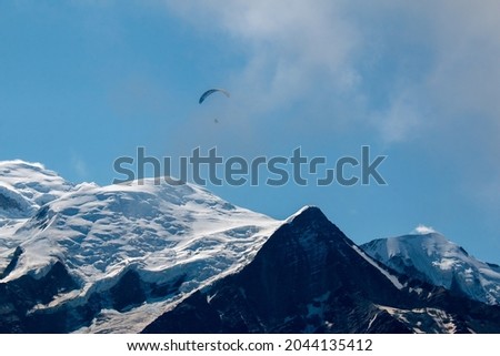 A tiny figure of a paraglider in French Alps. The view towards Mont Blanc from a hiking trail between Les Houches and Refuge de Bellachat (near Chamonix). Photo stock © 