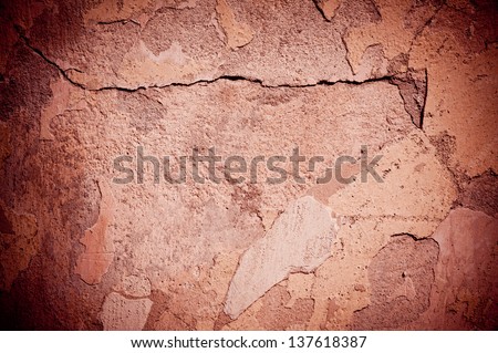 Brown old cracked paint texture damaged wall abstract, broken paint surface abstract of brown tinted background with dark vignette in horizontal orientation, nobody.