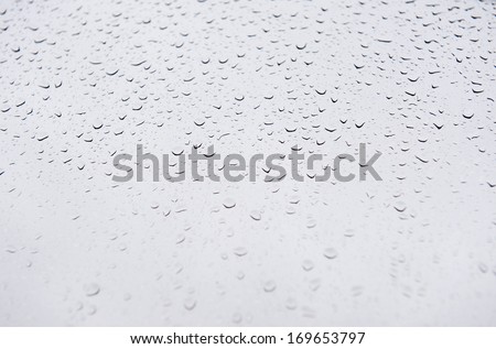 Raindrops on window glass blurred abstract, transparent glass of window. Horizontal orientation, nobody.
