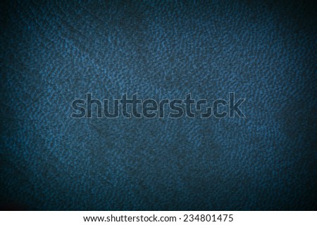 Navy leather texture abstract, gloomy blue tinted leather imitation material sheet, rough surface background in horizontal orientation, nobody.
