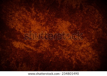 Vintage stained cloth sheet texture abstract, dark red orange tinted rough material surface and dark vignette background in horizontal orientation, nobody