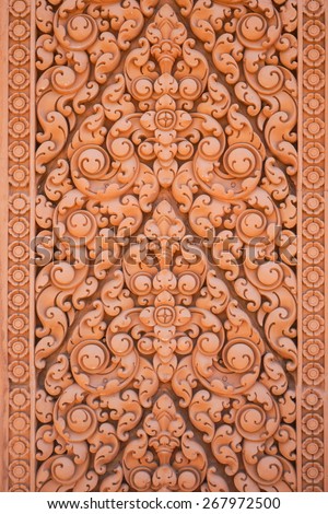 Thai traditional carving used for decoration on the wall of Buddhist church.