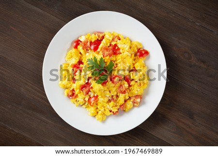 Similar – Image, Stock Photo Fried eggs with tomatoes and broccoli in white frying pan on kitchen table with ingredients. Top view. Healthy breakfast