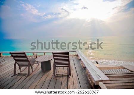 wood chairs on terrace, sea view and sunshine