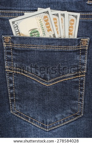 Cash in dark blue jeans pocket closeup
