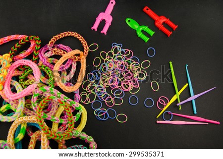 Bright bracelets with elastic rubber on black background.