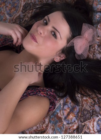 beautiful young woman with bow in the hair