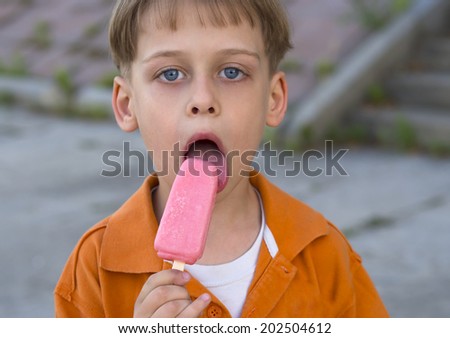 cute boy with blue eyes enjoying ice cream