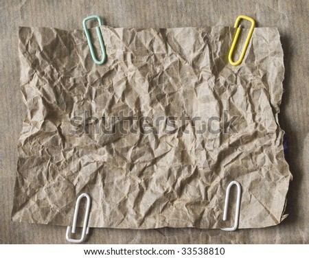 brawn wrinkled paper with colorful clips